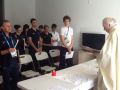 Don Lusek officiates the first Olympic Mass at the Village.  "Work and sacrifice in order to see the light of success"